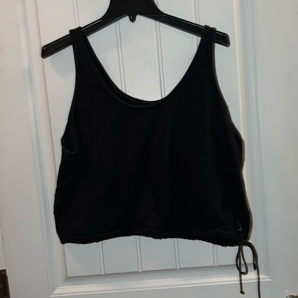 Nike cropped work out shirt with tie on bottom. No stains or holes.